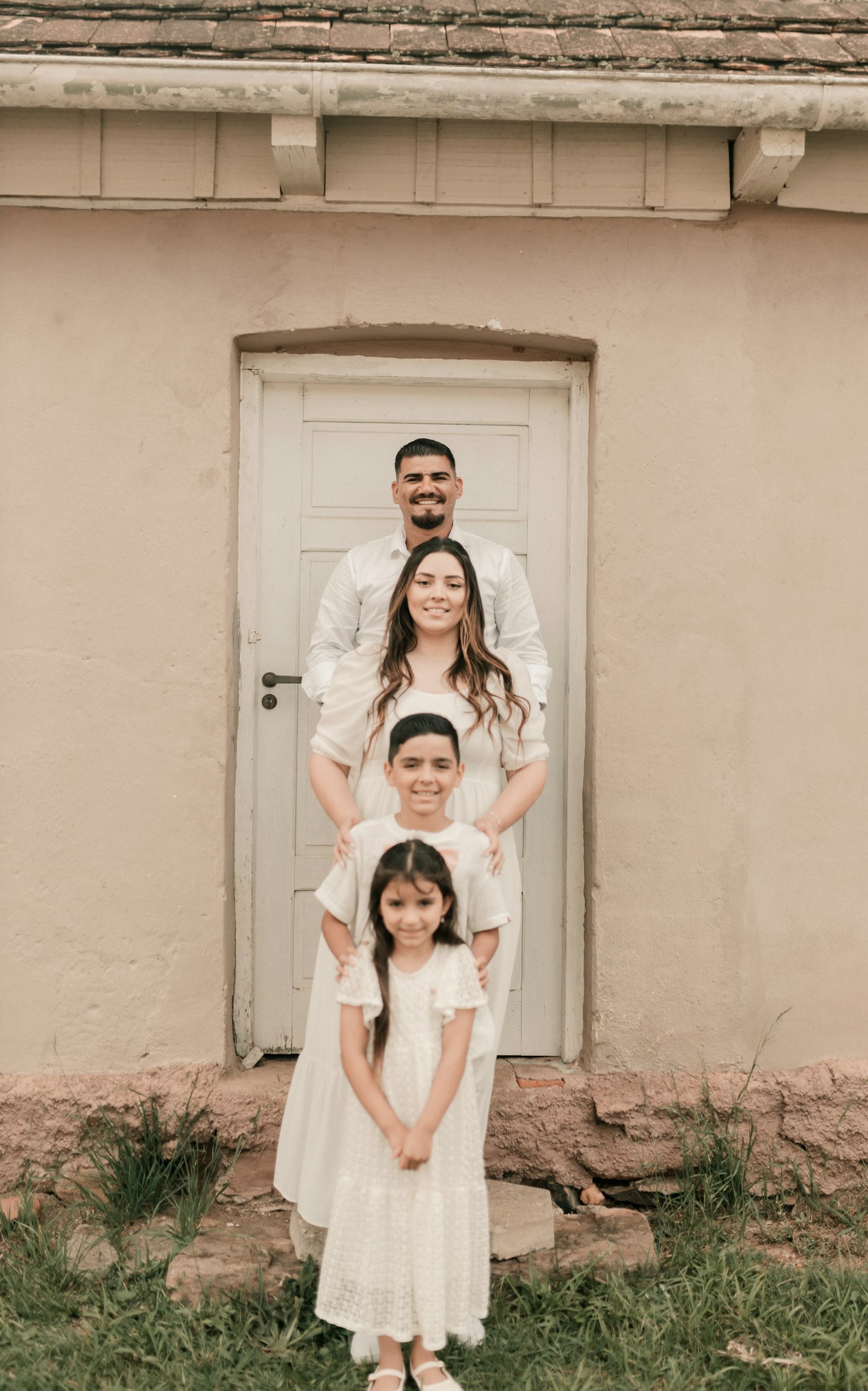 Family standing outside their home